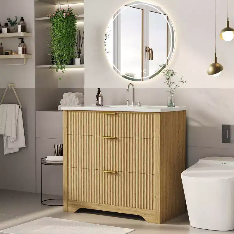Meuble-lavabo de salle de bain moderne cannelé avec lavabo en céramique intégré, armoire de rangement autoportante avec 3 tiroirs pour salle de bain contemporaine.